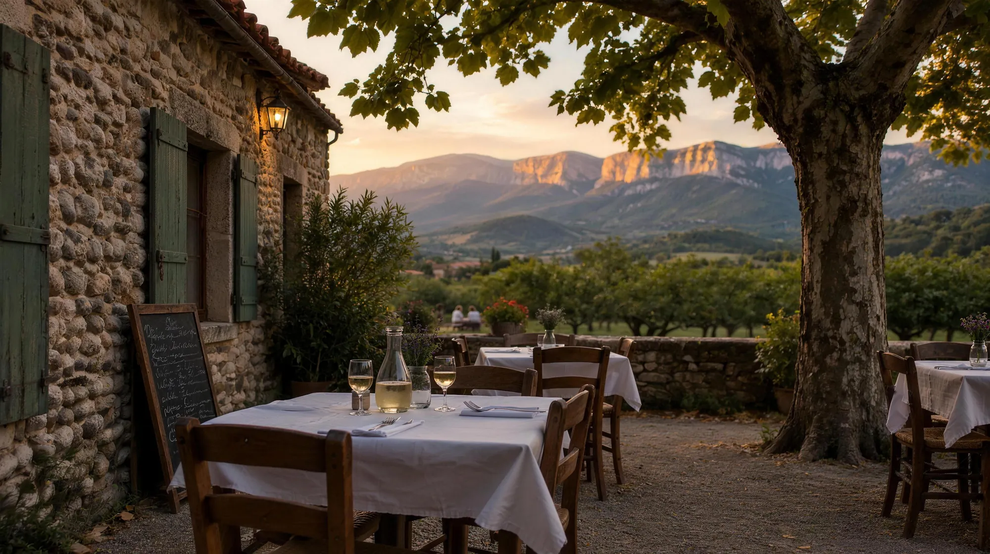 A village restaurant terrace in the late afternoon, facing the Vercors